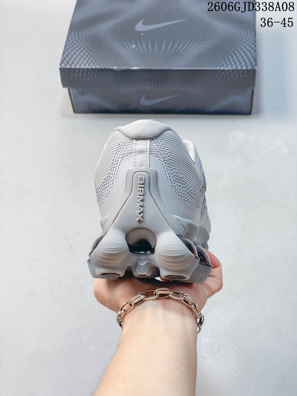 Rear view of a light grey Nike Air Liquid Max sneaker with a sculpted heel