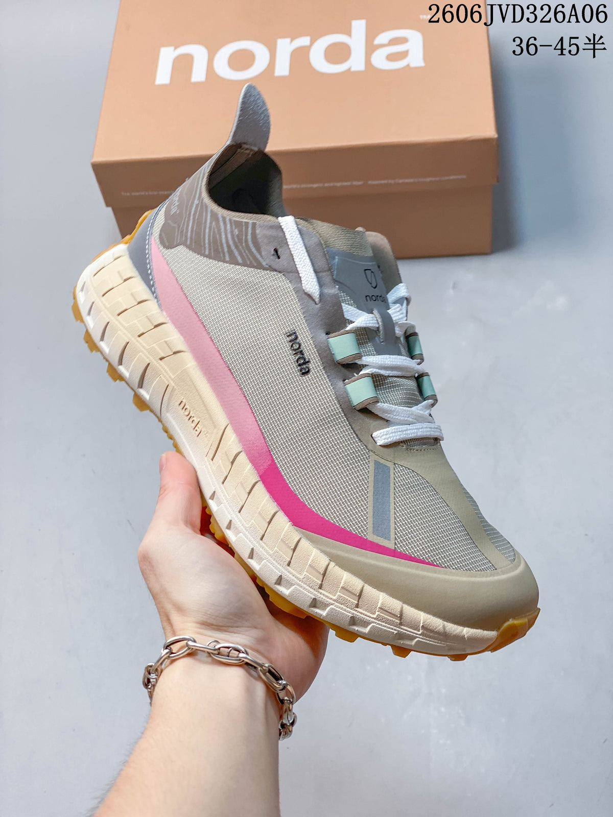 Angled side view of the taupe sneaker with pink accents and pull tab.
