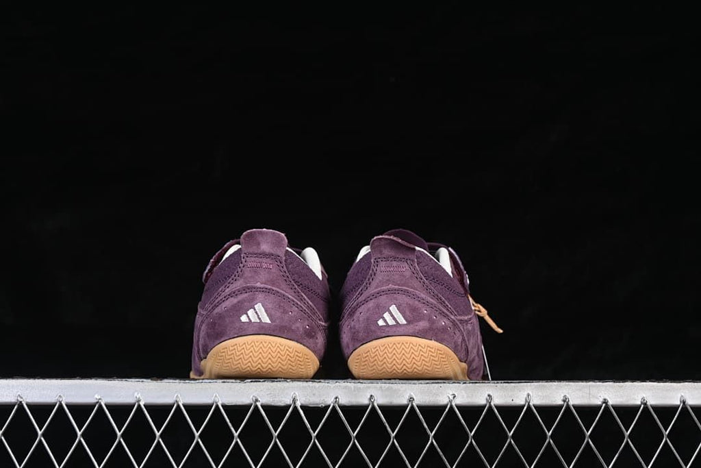 Rear view of both sneakers showing white adidas logos and gum outsoles