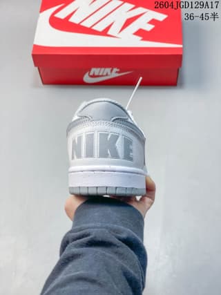 Rear view of the sneaker showing the branded heel panel, layered heel construction and grey outsole edge.