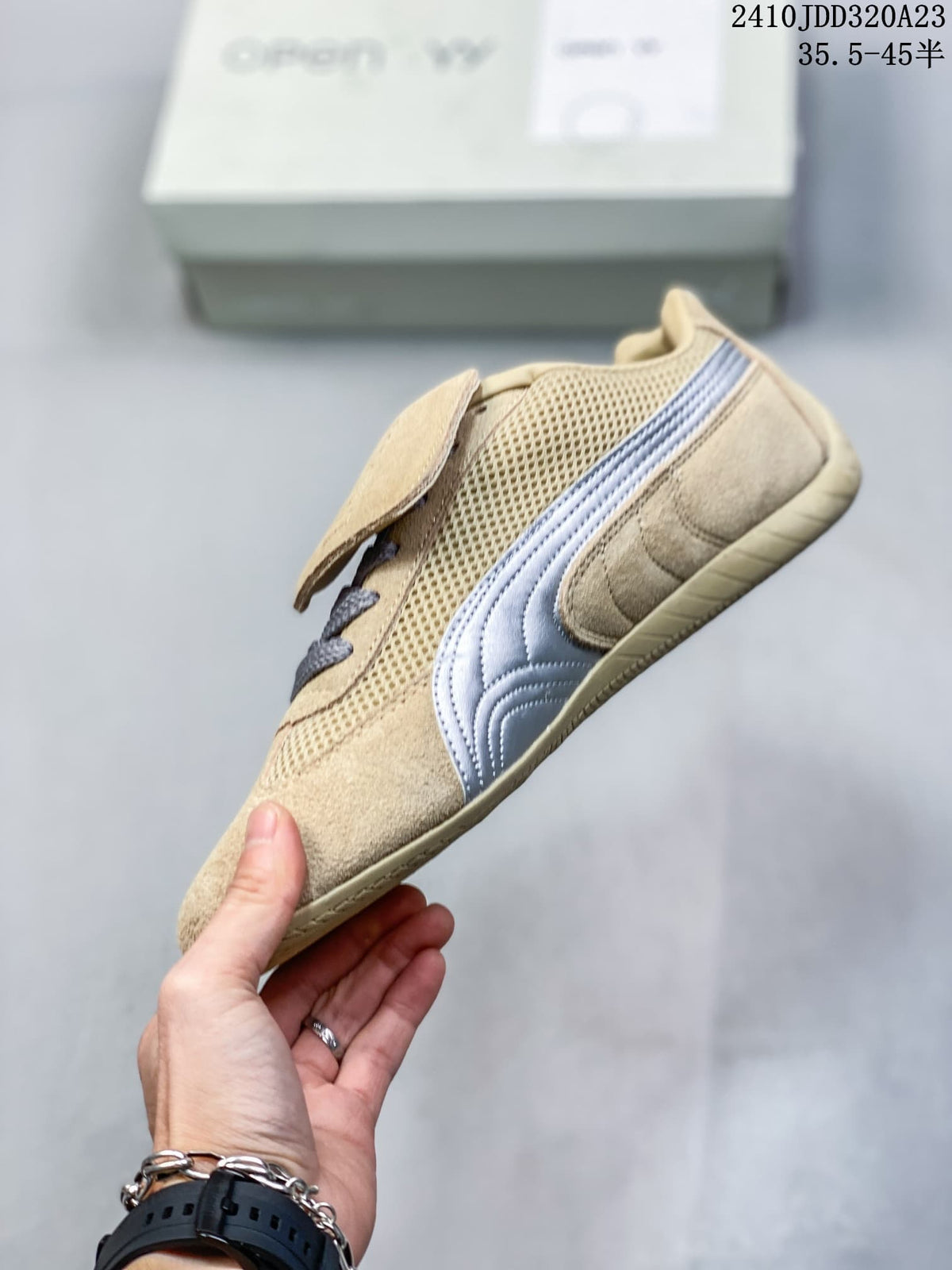 Side profile of a beige Speedcat sneaker with mesh panels and a silver stripe.