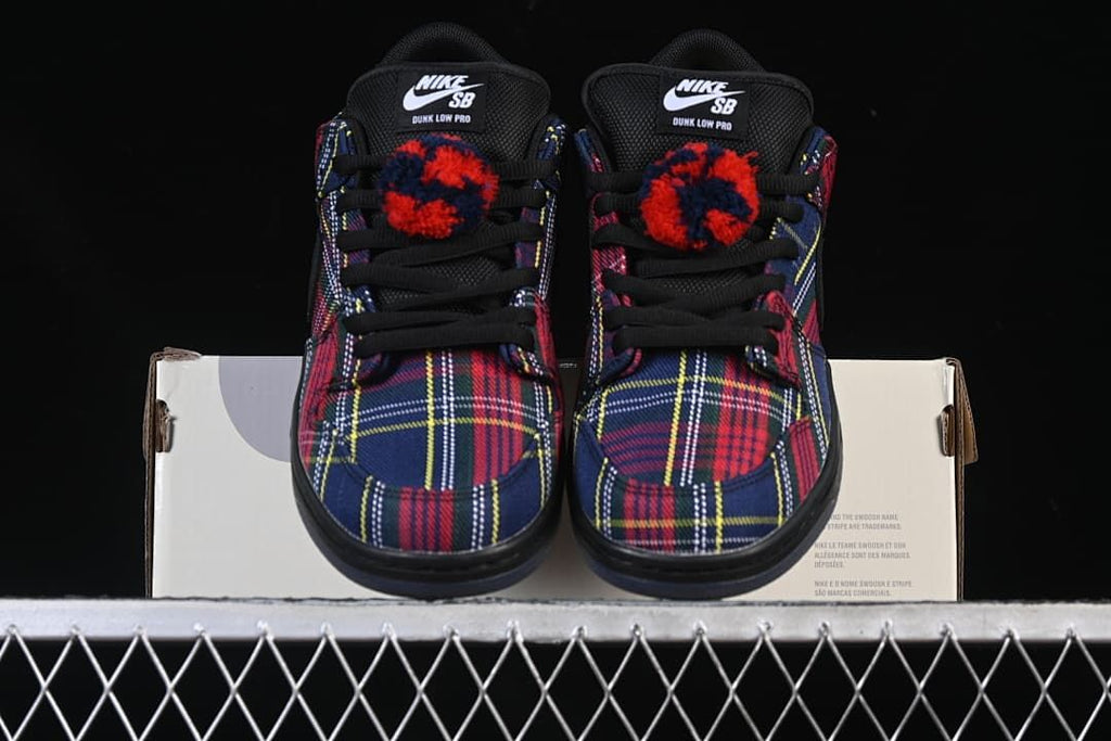 Front view of the pair showing plaid toe boxes and fuzzy lace details.