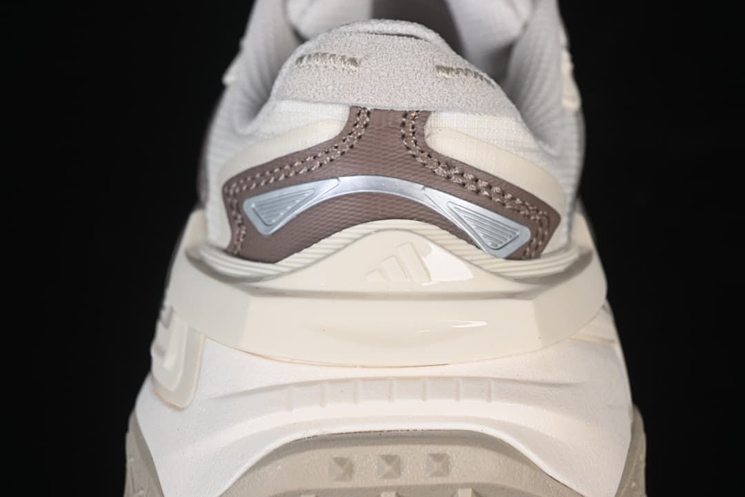 Rear view highlighting the layered heel design and brown and silver-toned details.