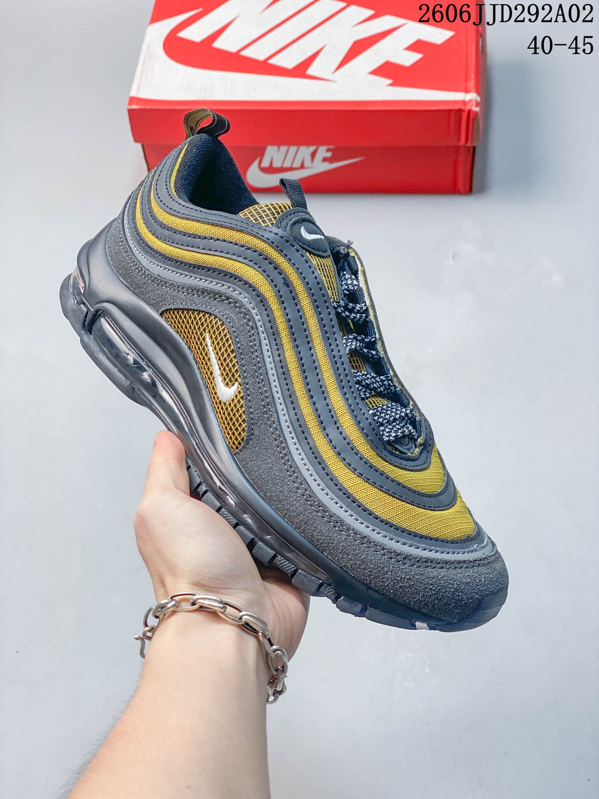 Angled side view of the Nike Air Max 97 in gray, yellow, and navy