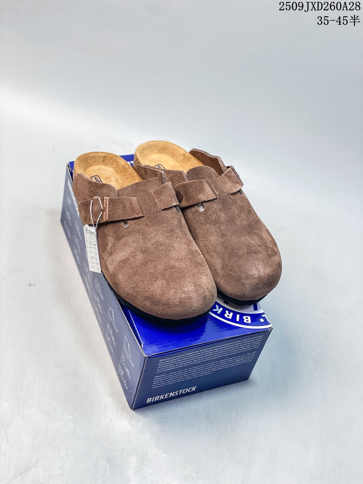 Pair of brown closed-toe buckle mules displayed on a Birkenstock-branded box