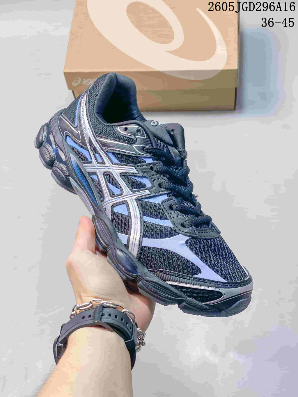 Black ASICS Gel-Cumulus 16 sneaker with blue and silver-colored accents.