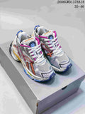 Pair of silver and white Balenciaga Runner sneakers with multicolor accents, viewed from the front
