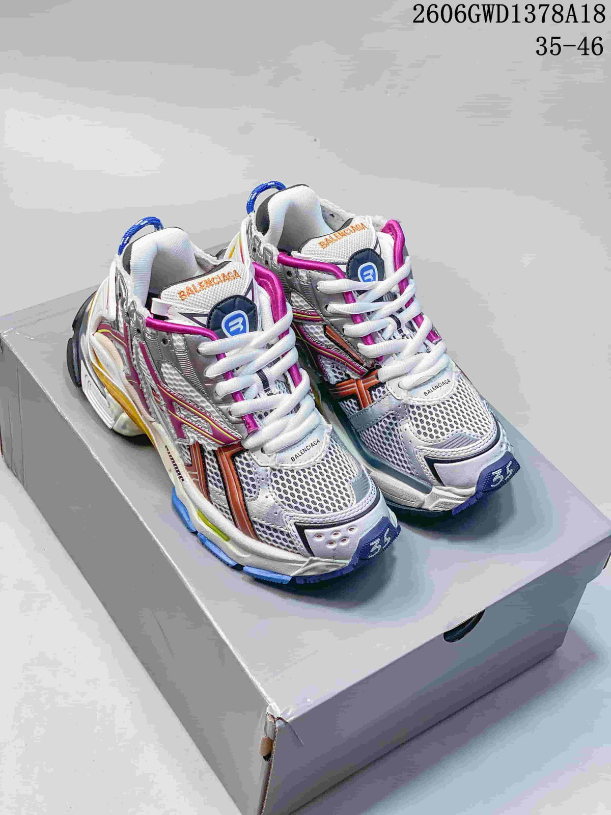 Pair of silver and white Balenciaga Runner sneakers with multicolor accents, viewed from the front