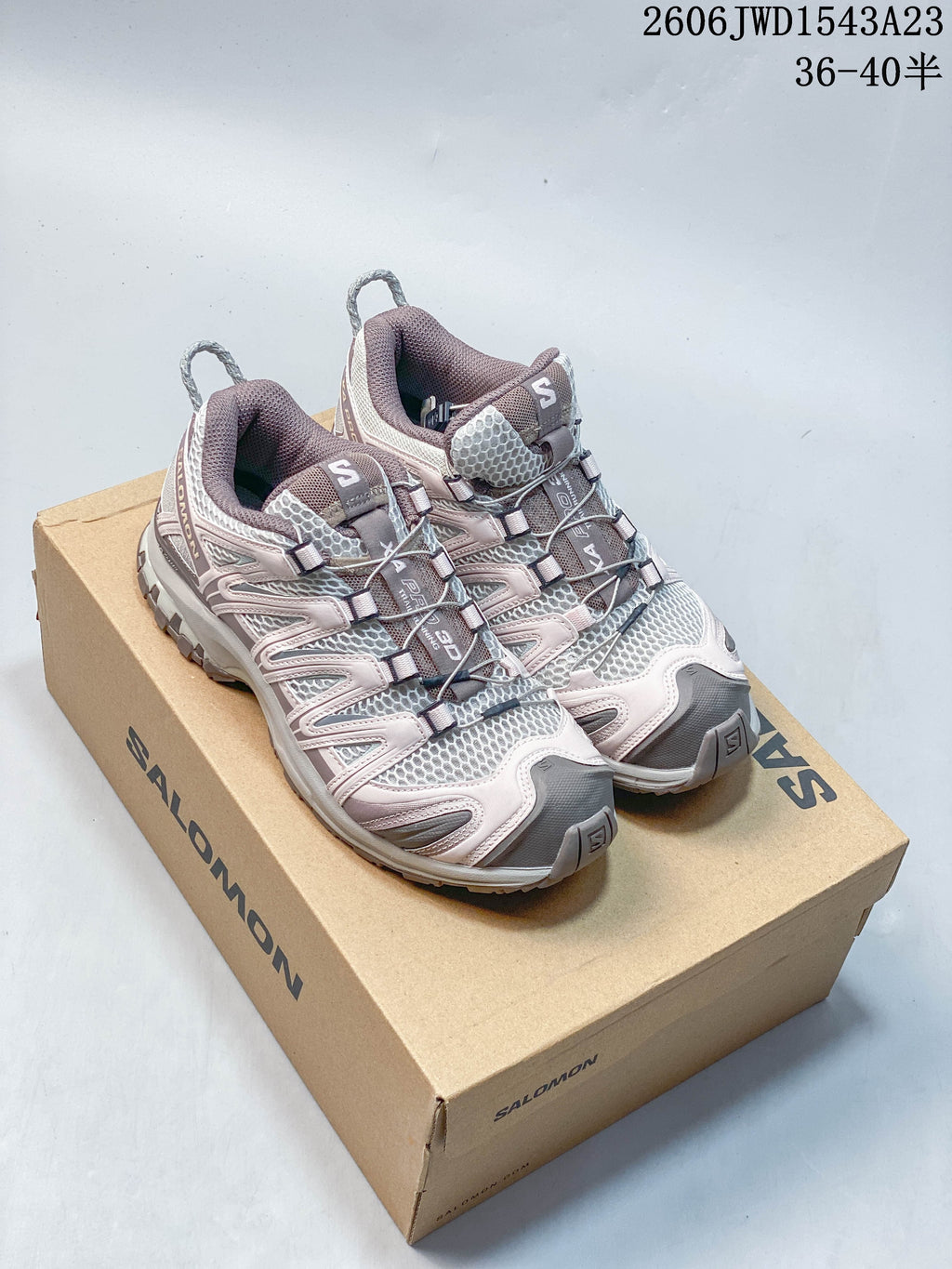 Pair of mauve, gray, and pale pink Salomon XA Pro 3D shoes on a branded box; image overlay lists sizes 36–40.5.