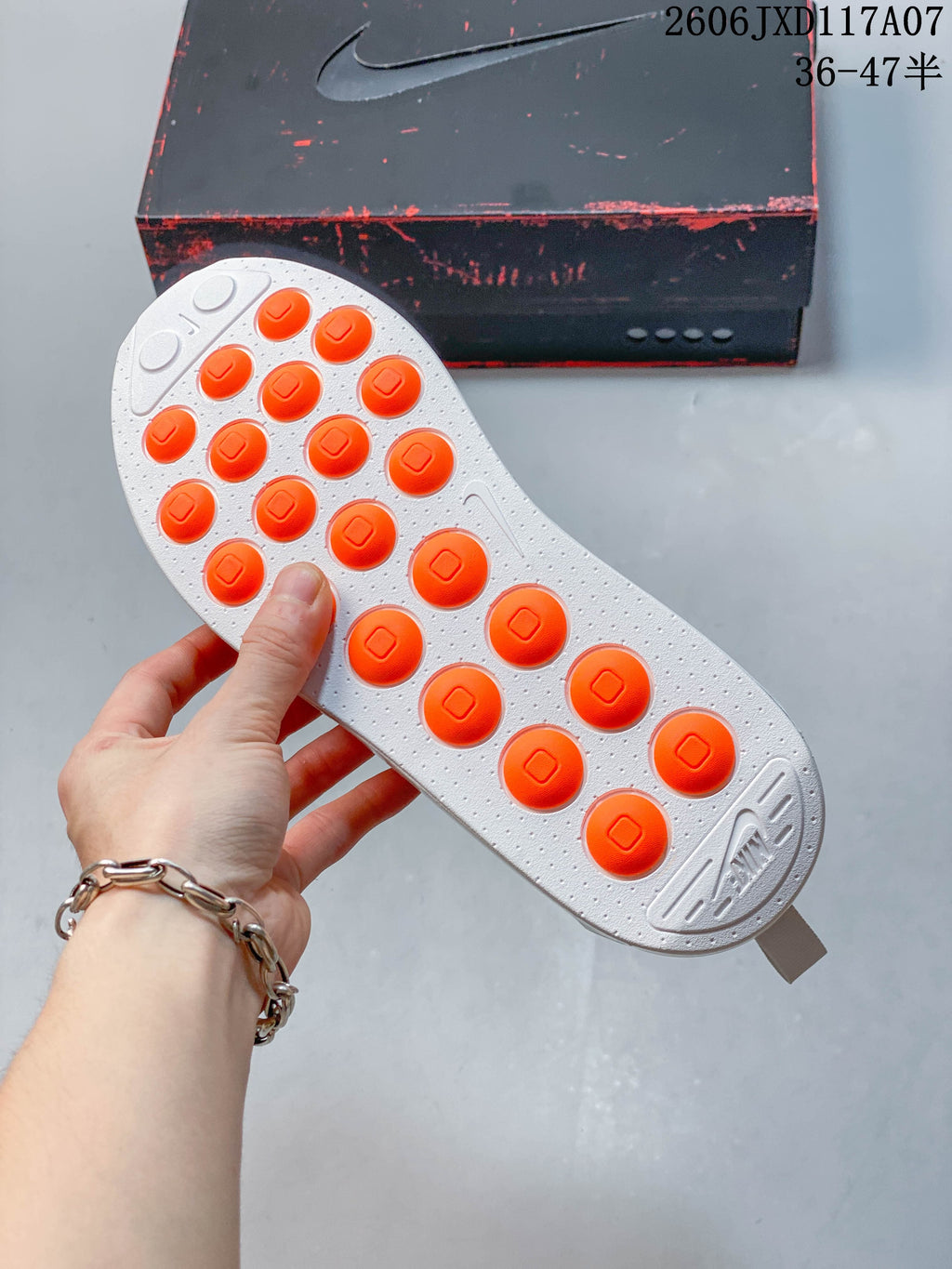 Outsole of the Nike Air Max 1 sneaker with orange circular tread details