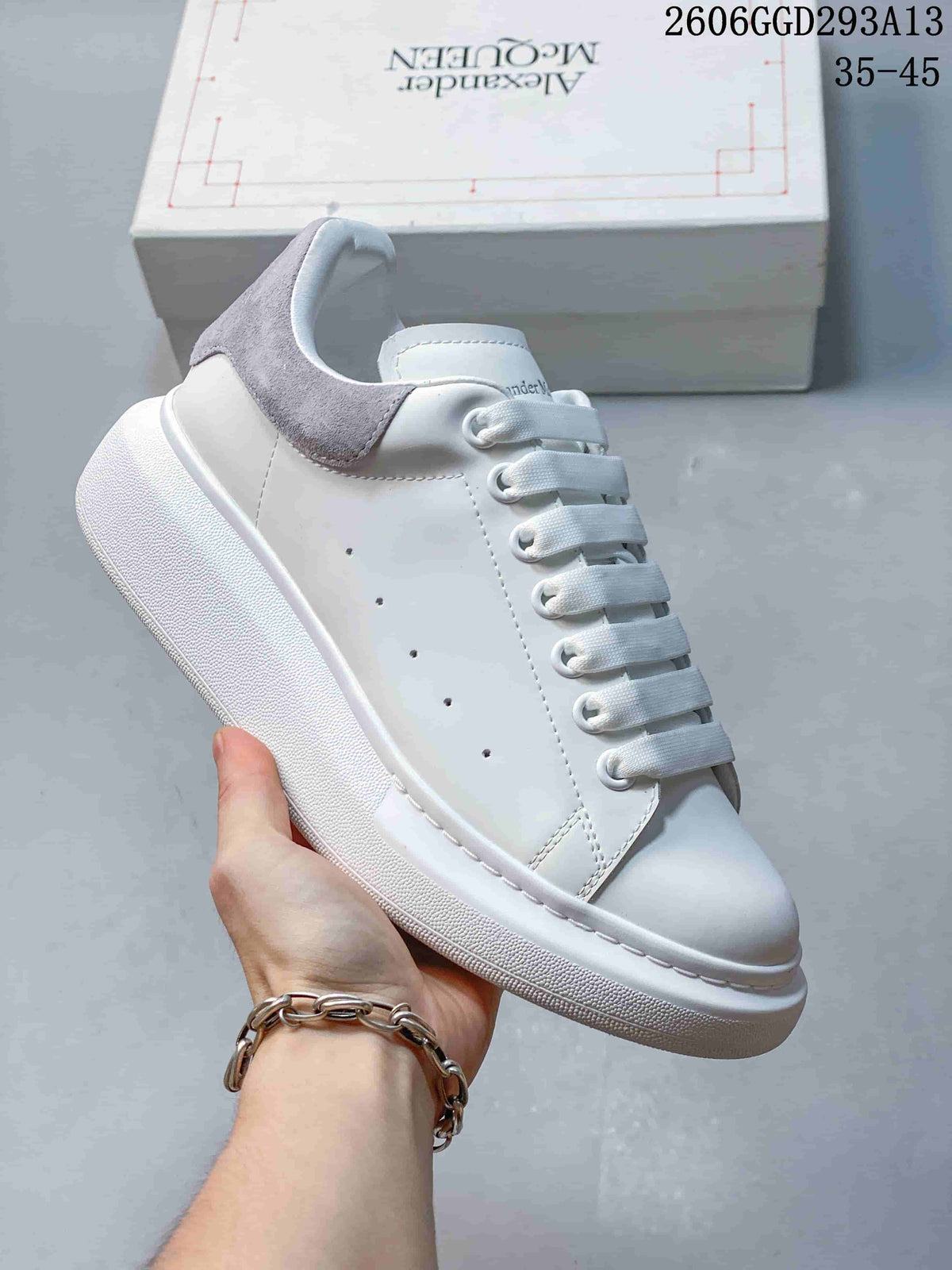 Angled side view of a white low-top sneaker with a gray heel panel