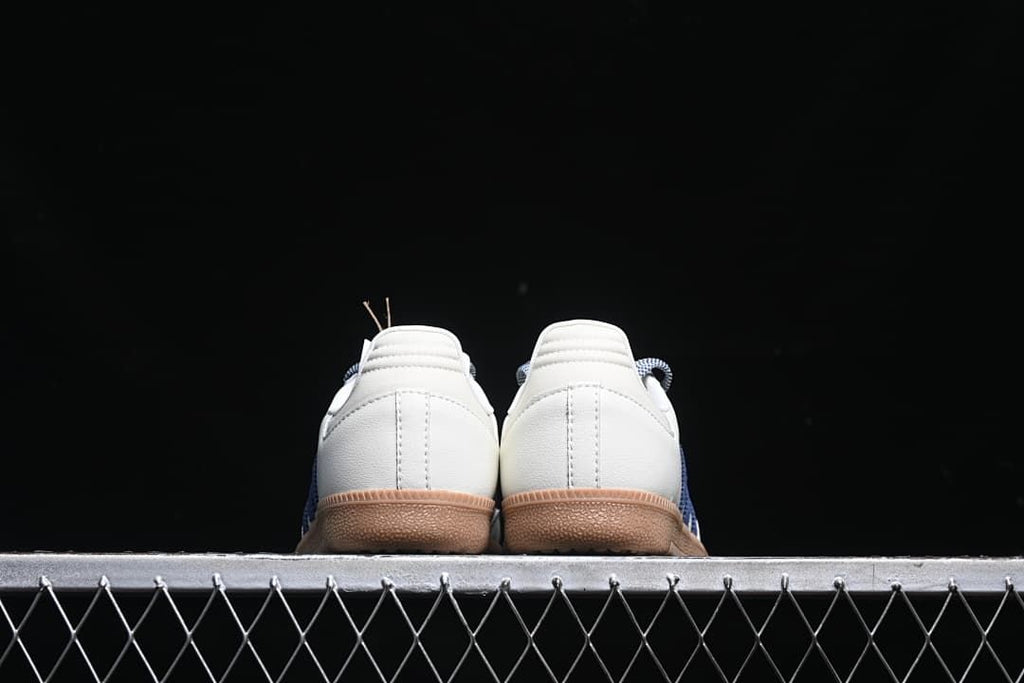 Rear view of both sneakers showing the heel panels and gum-colored soles.