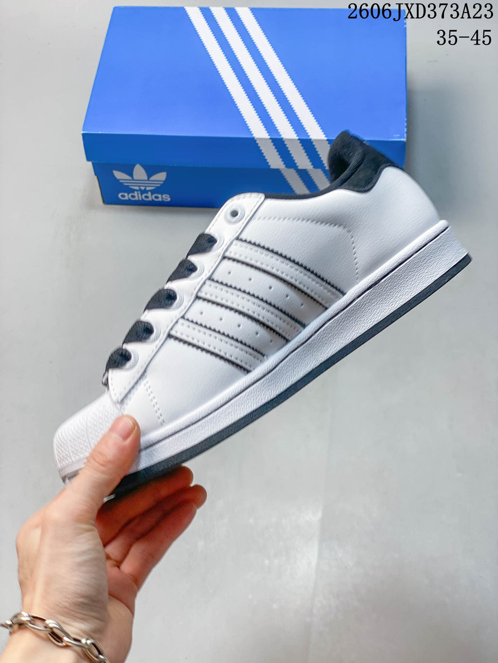 Side profile showing the three stripes and low-top silhouette