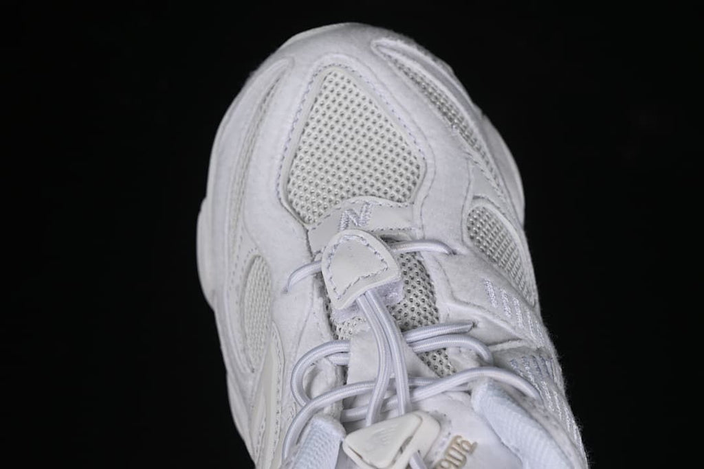 Top view of the toe box, mesh panels, and elastic laces.