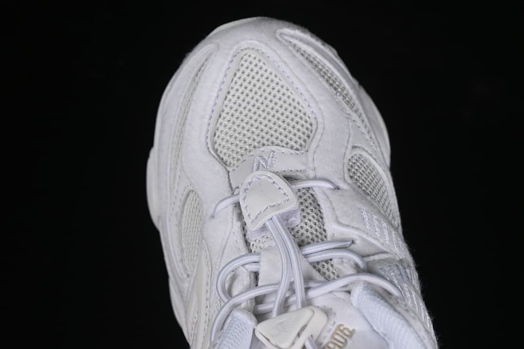 Top view of the toe box, mesh panels, and elastic laces.