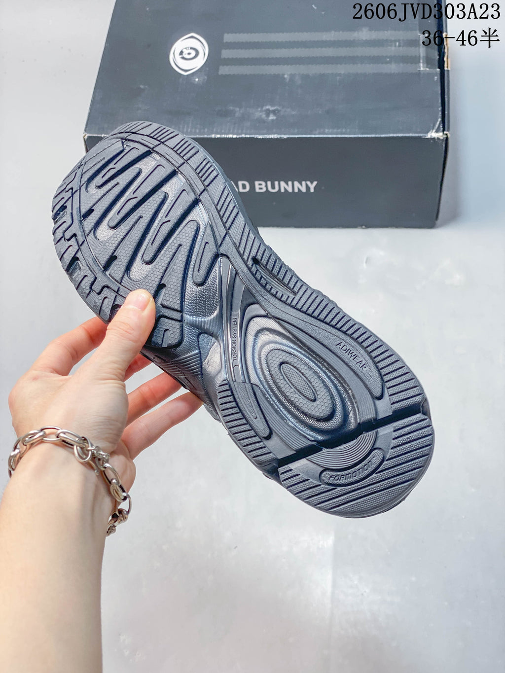 Close-up of the patterned outsole on a charcoal gray sneaker