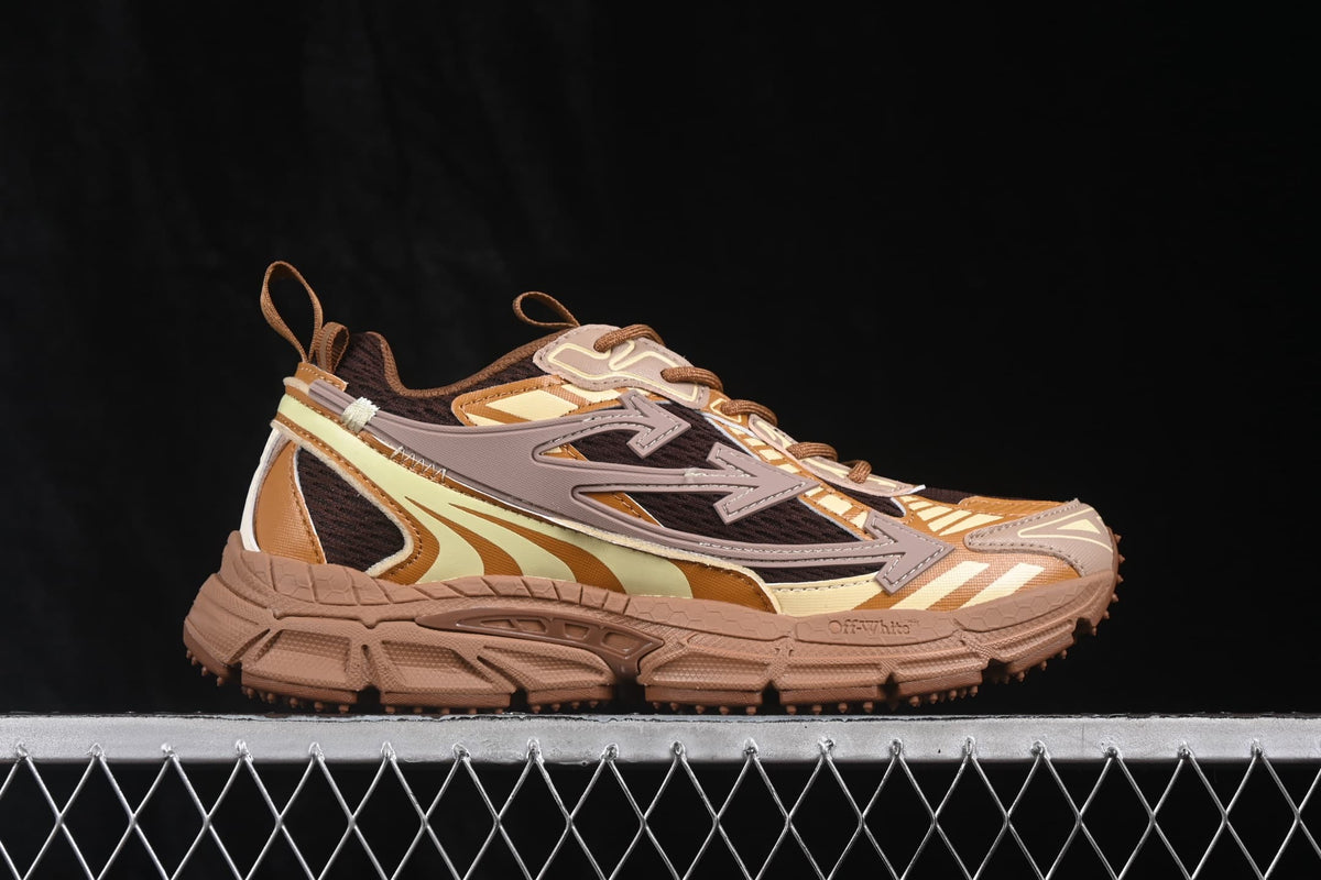 Opposite side profile showing the layered upper, large arrow-style side detail, pull tabs and brown sole.