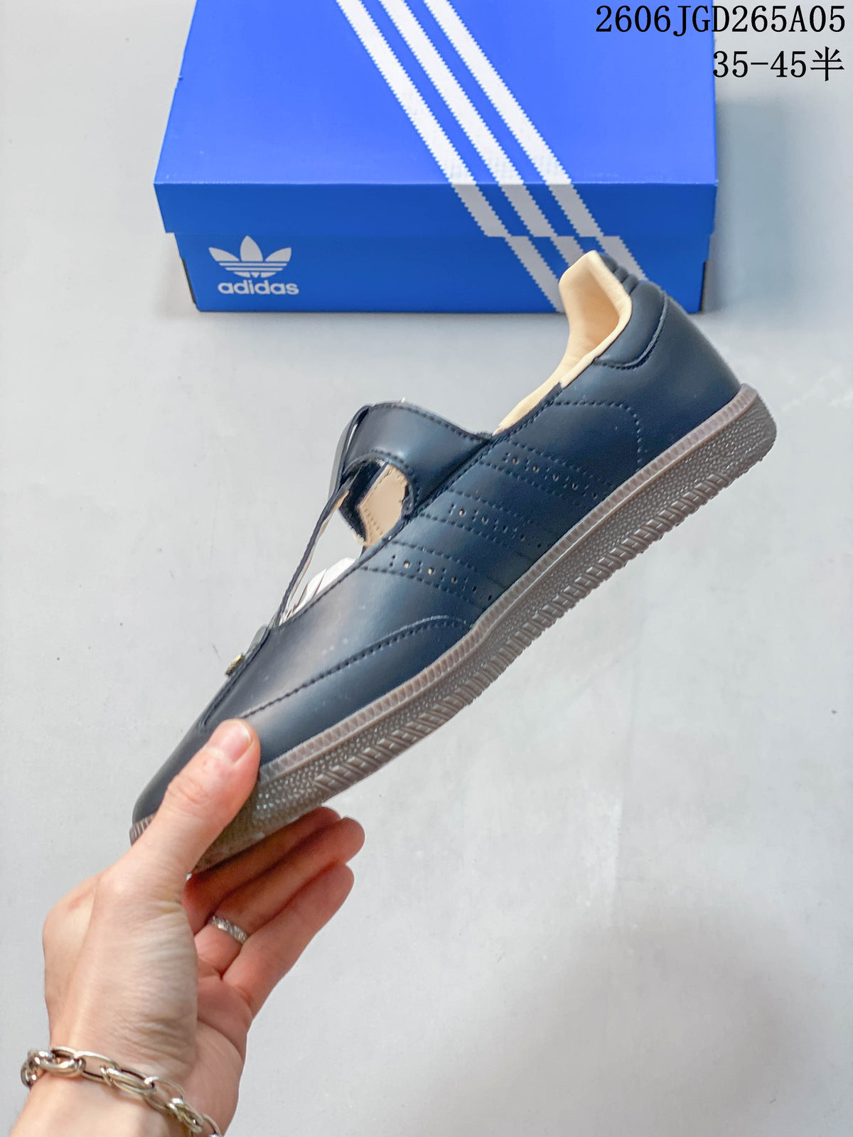 Side profile of a dark adidas Samba Jane sneaker with perforated stripes