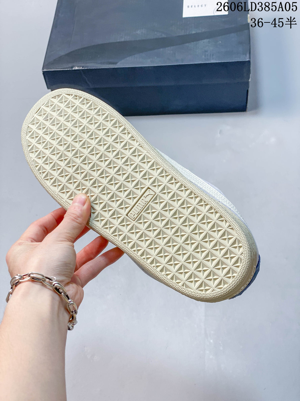 Close-up of the cream-colored outsole with a geometric tread pattern