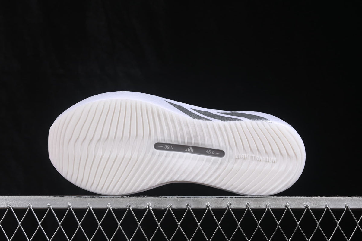 Underside view showing the textured white outsole and printed size markings on the photographed sample.