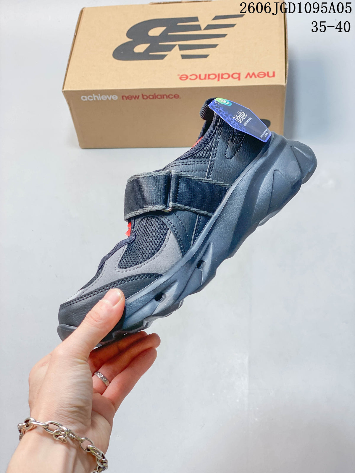 Side view of a gray New Balance Breeze sneaker with a broad instep strap