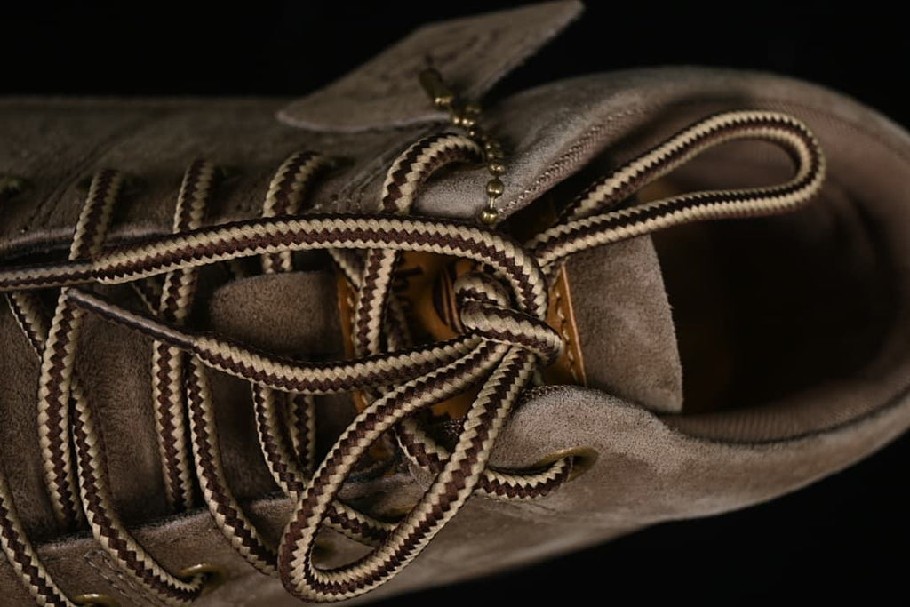 Close-up of the boot's contrast laces and metal eyelets