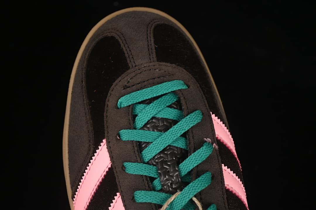 Top-down detail of the sneaker's toe and teal laces.