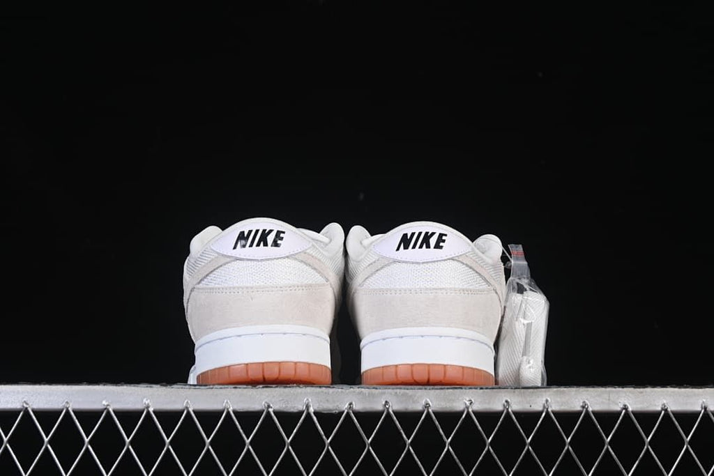 Rear view of both sneakers showing heel branding and gum outsoles