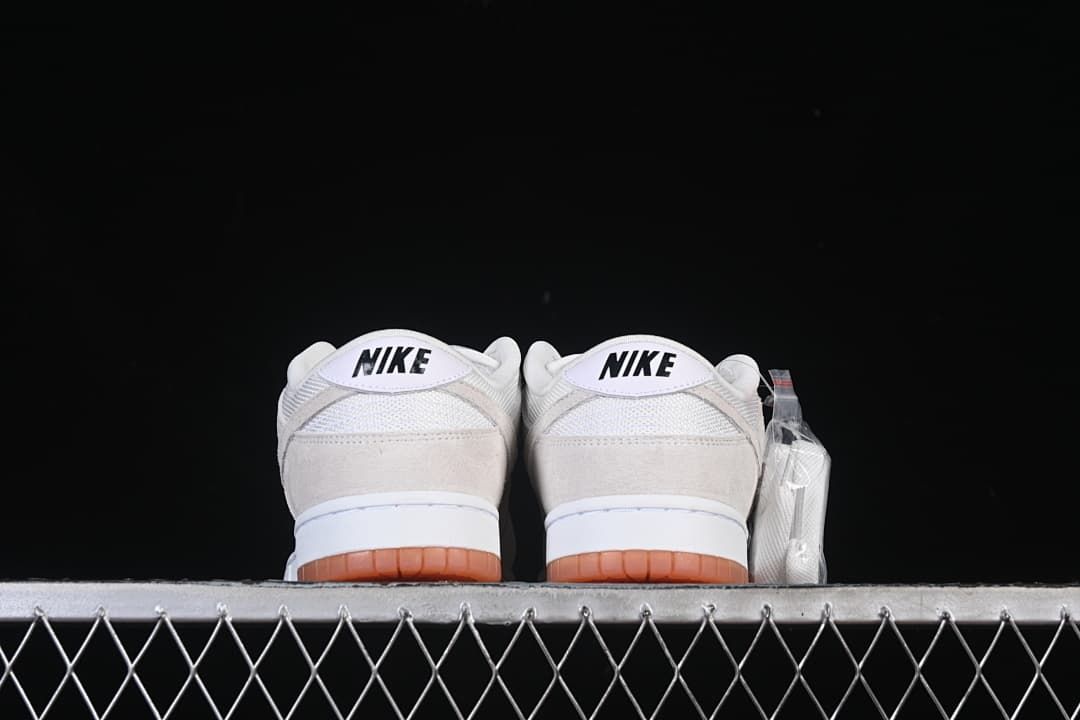 Rear view of both sneakers showing heel branding and gum outsoles
