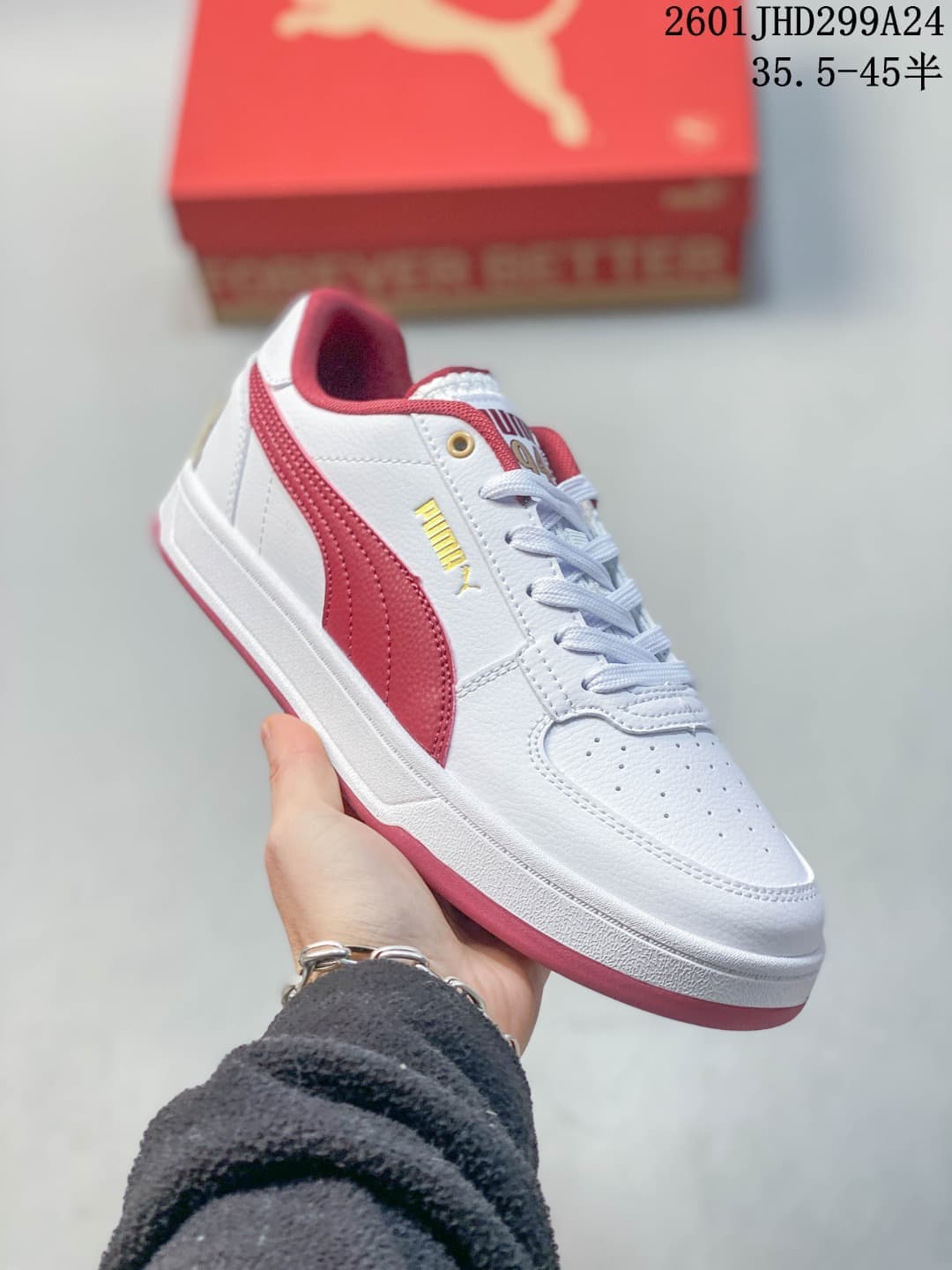Angled side view of a white Puma Caven 2.0 sneaker with red accents