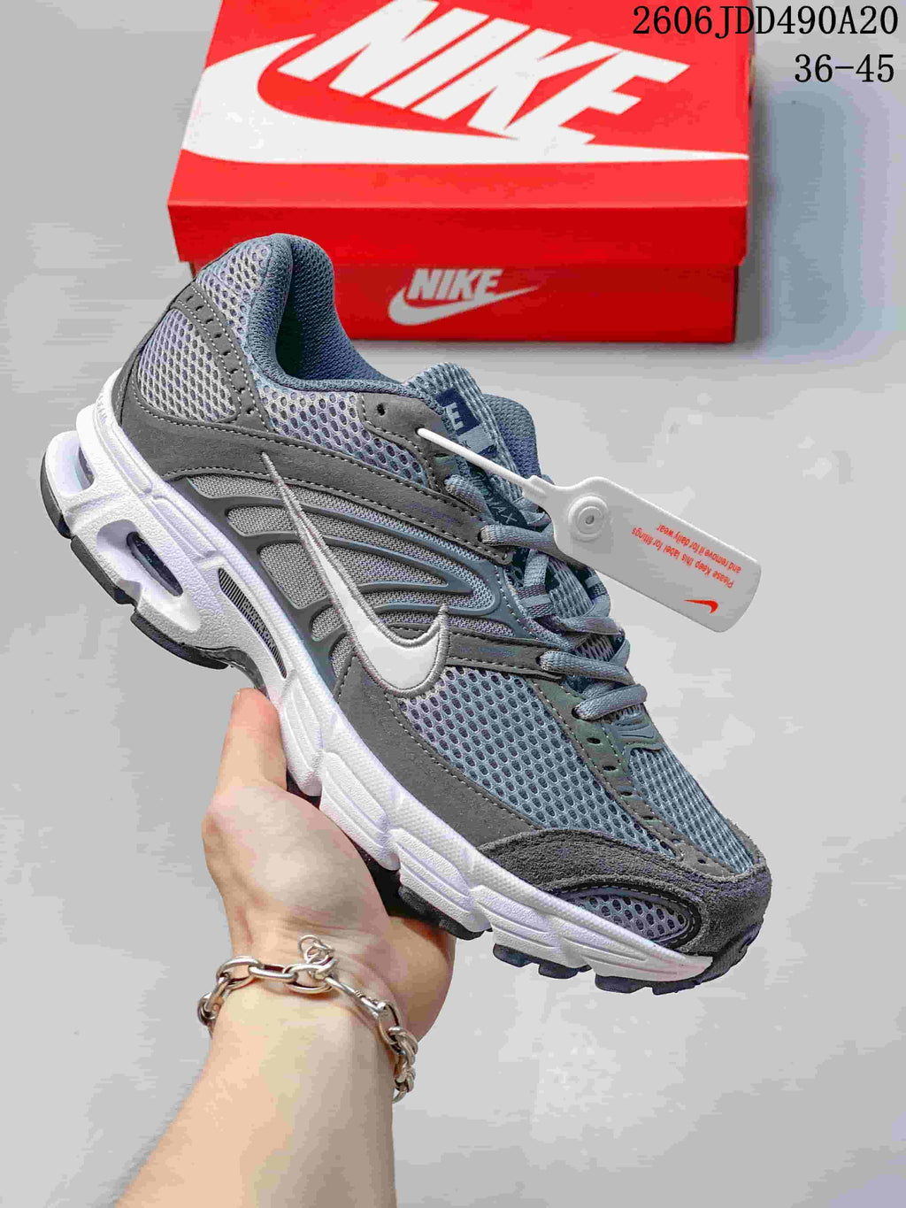 Gray mesh Nike Air Max Moto 2K sneaker with a white Swoosh and white sole