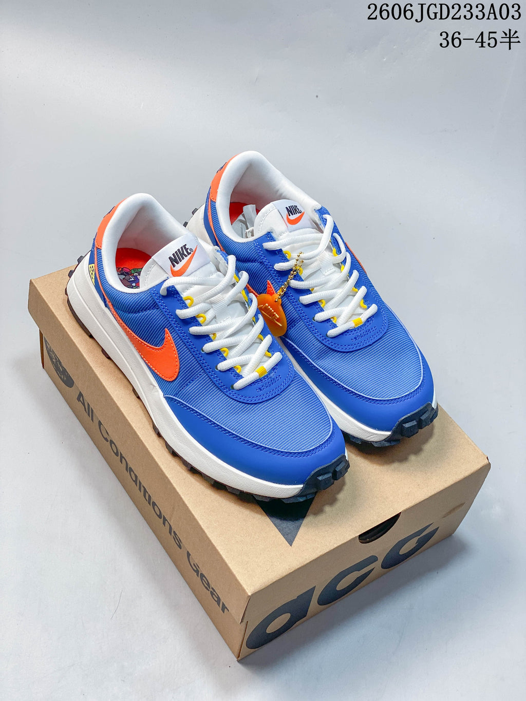 Blue and orange Nike ACG low-top sneakers shown on a box