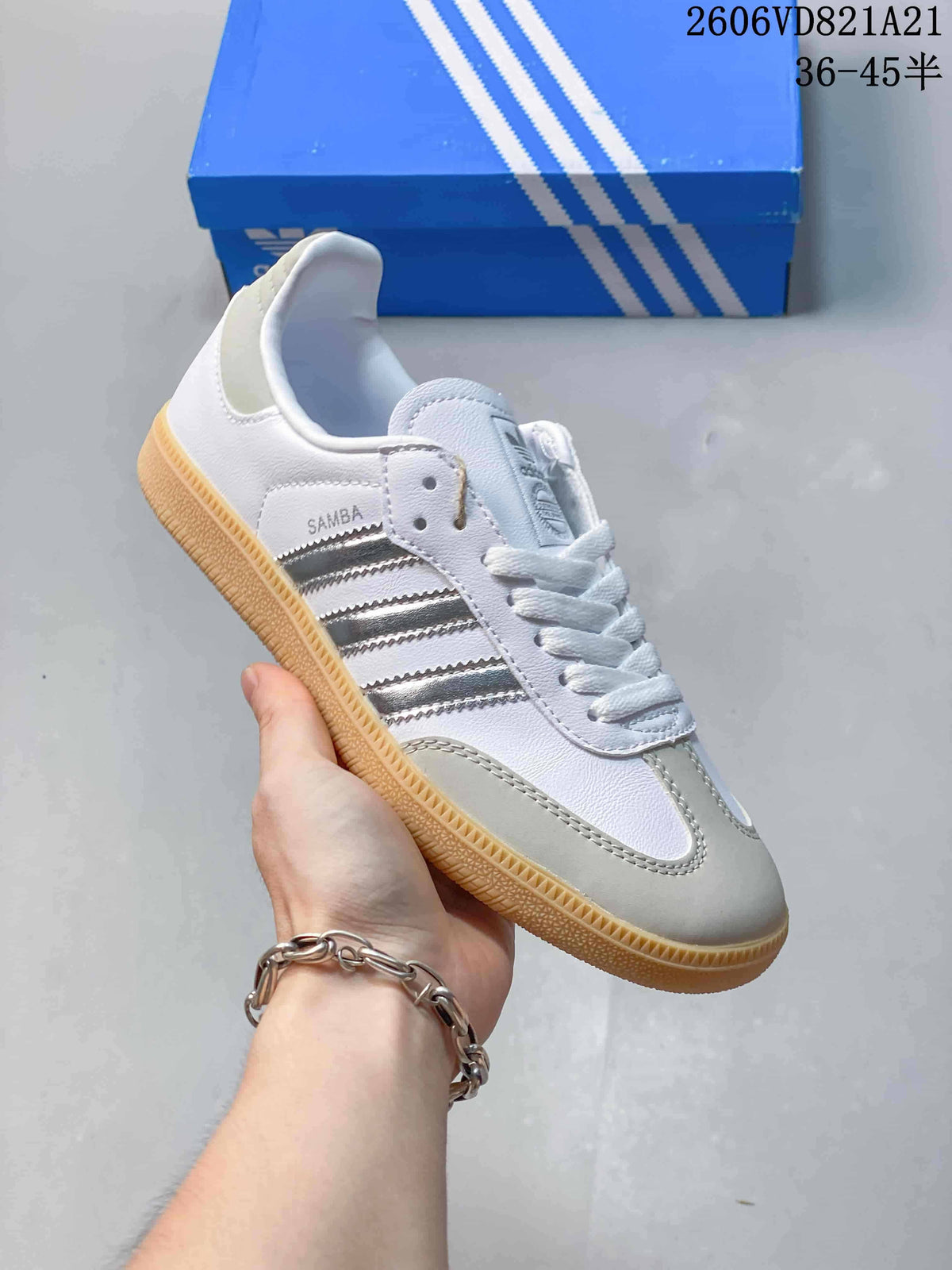Angled side view of a white adidas Samba sneaker with silver-tone stripes and a gum-colored outsole.