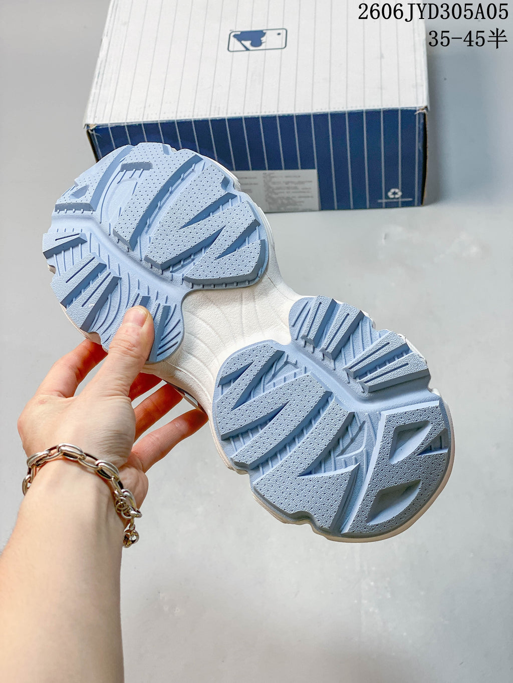 Close-up of the sneaker outsole showing its light blue tread pattern.