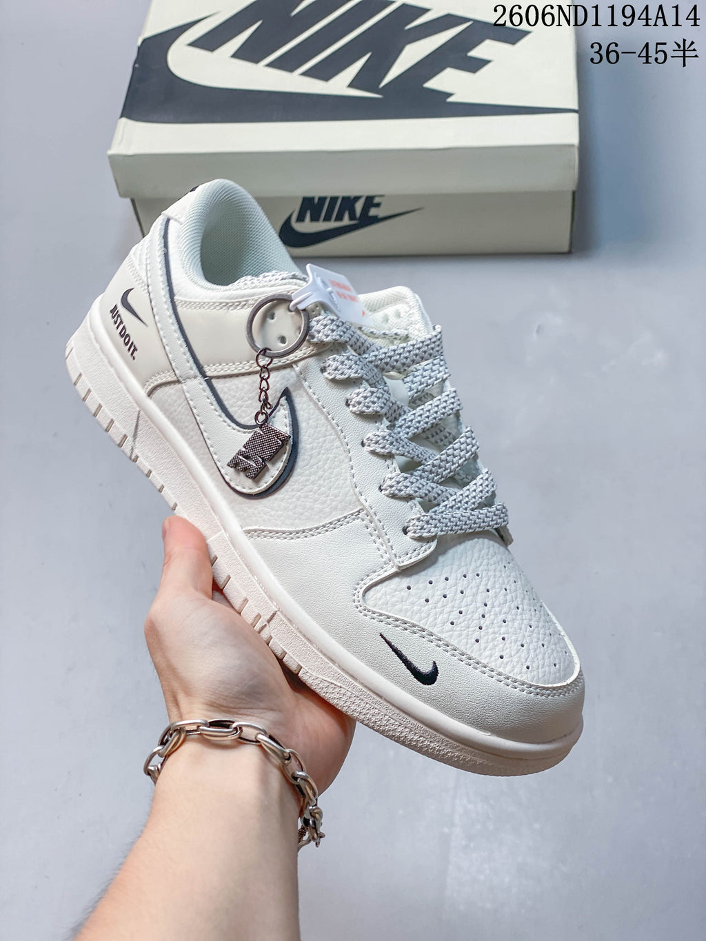 Angled view of the sneaker with decorative lace tag and charm