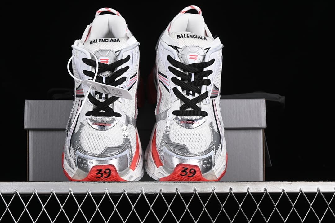 Front view of the pair showing black laces, silver-toned toe overlays and red toe details marked 39.