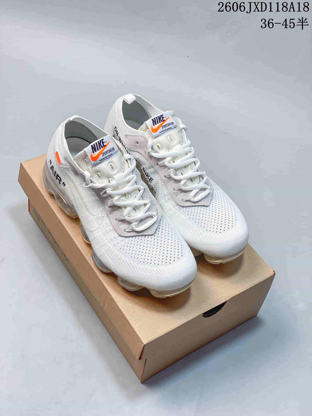 Pair of white low-top sneakers with knit-look uppers and segmented transparent-looking soles.