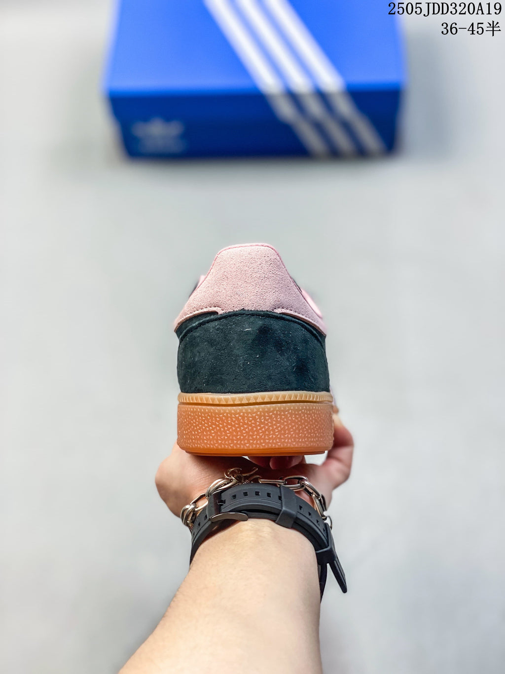 Rear view showing the navy heel, pink heel panel, and gum sole