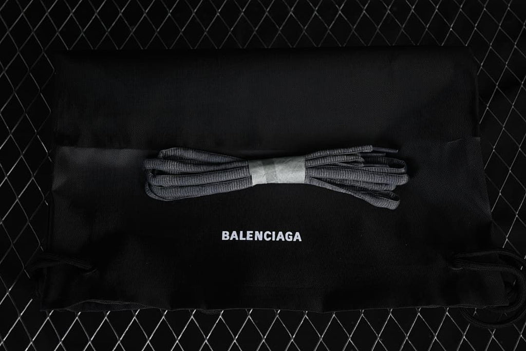 Black Balenciaga-branded dust bag with a spare set of grey laces