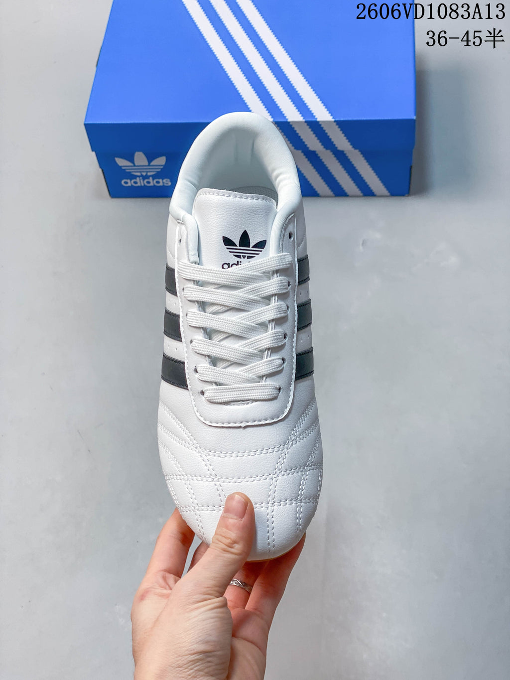 Top view of a white lace-up Taekwondo sneaker with stitched toe detailing