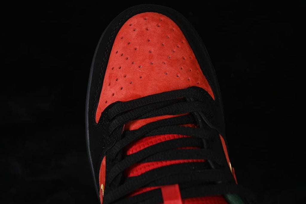 Top-down close-up of the red-orange perforated toe box and black laces.