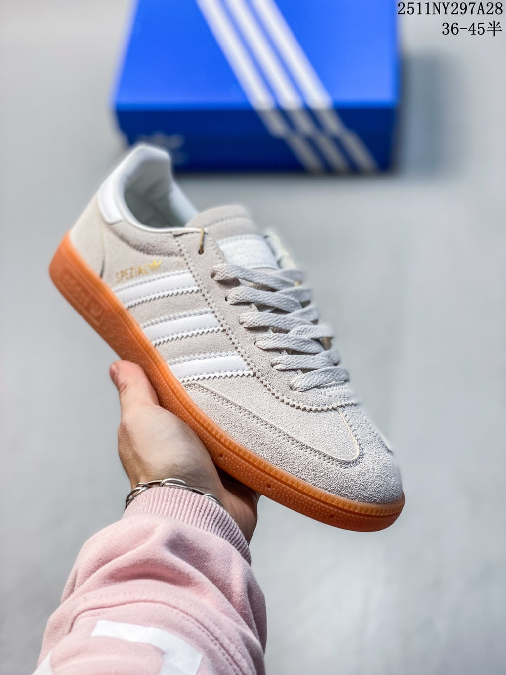 Light gray Adidas Spezial-style sneaker with white stripes and gum-colored outsole
