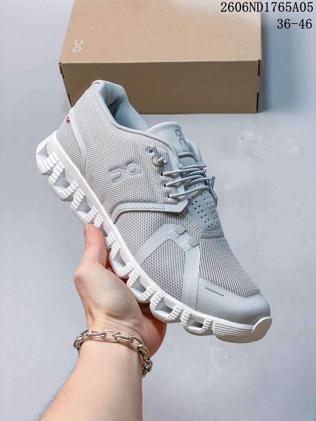 Angled side view of a light grey On Cloud 5 sneaker
