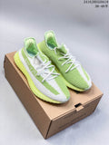 Pair of green and white Yeezy Boost 350 V2 sneakers on a box