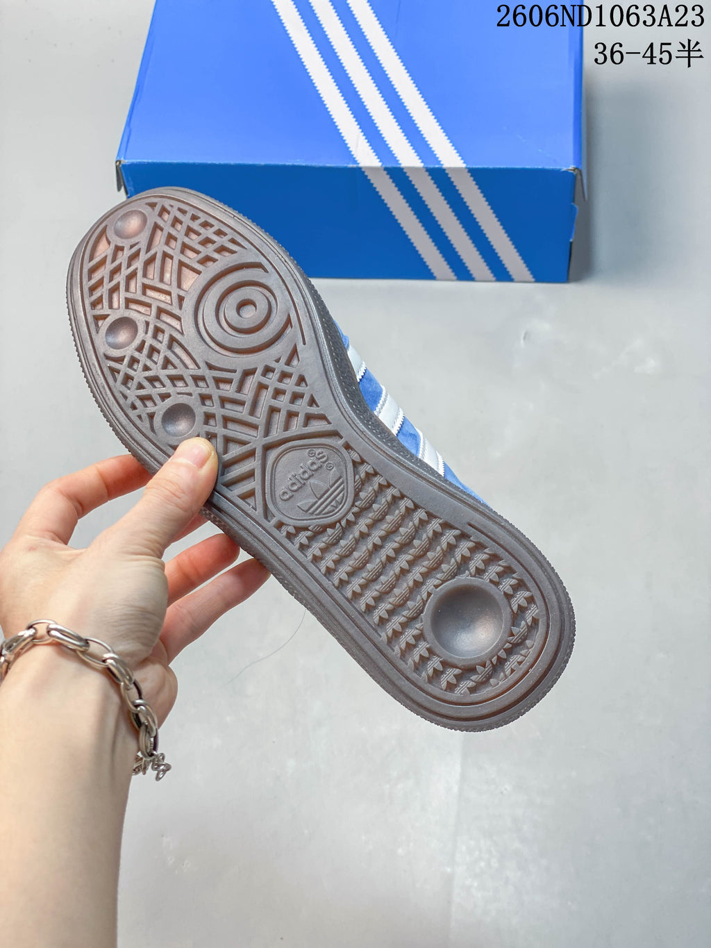 Close-up of the patterned dark outsole on the blue low-top sneaker