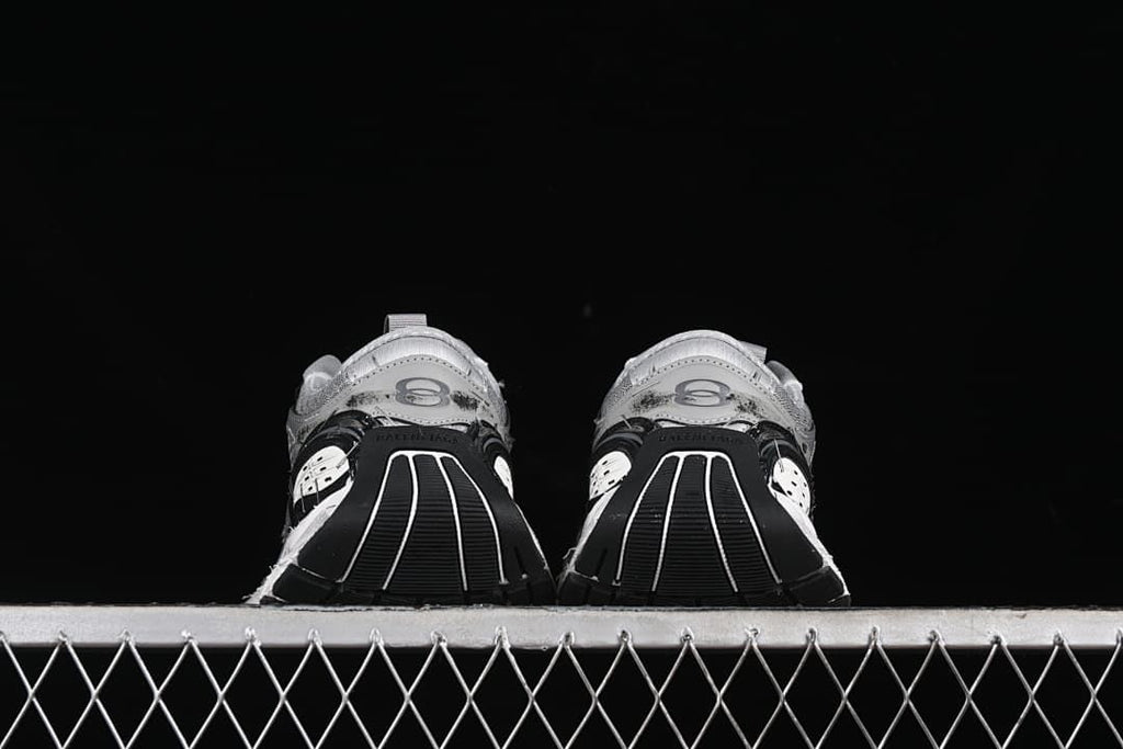 Rear view of both sneakers showing the heel and outsole design