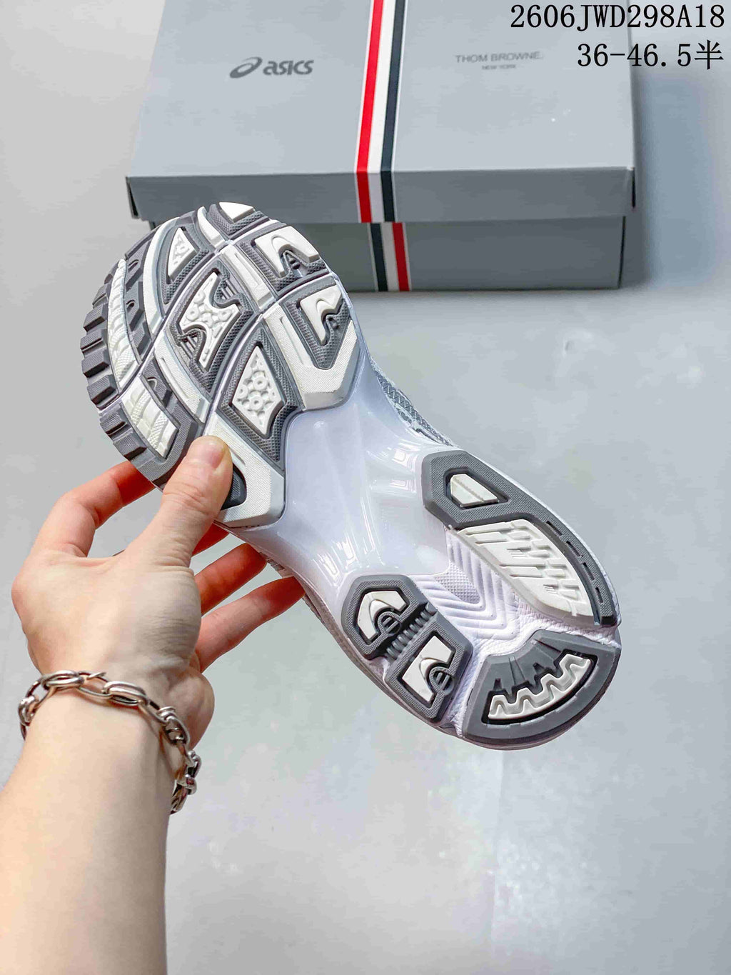 Underside view of the ASICS GT-2160 sneaker showing its segmented gray and white outsole