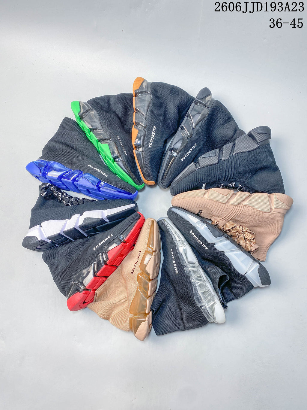 An assortment of Balenciaga sock-style sneakers in navy and blush pink color combinations with varied segmented sole accents.