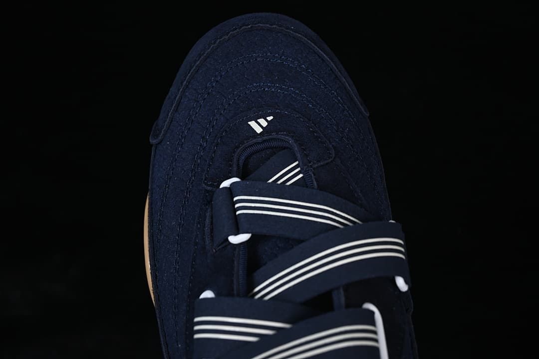 Top view highlighting the layered toe stitching and striped straps.