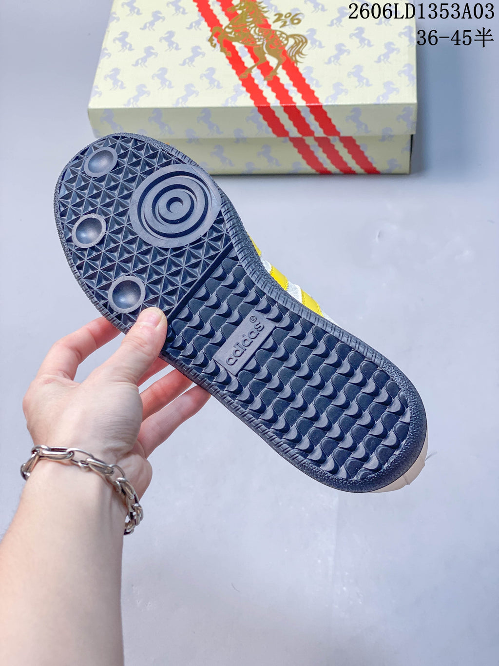 Close-up of the sneaker's patterned rubber outsole and horse-patterned box.